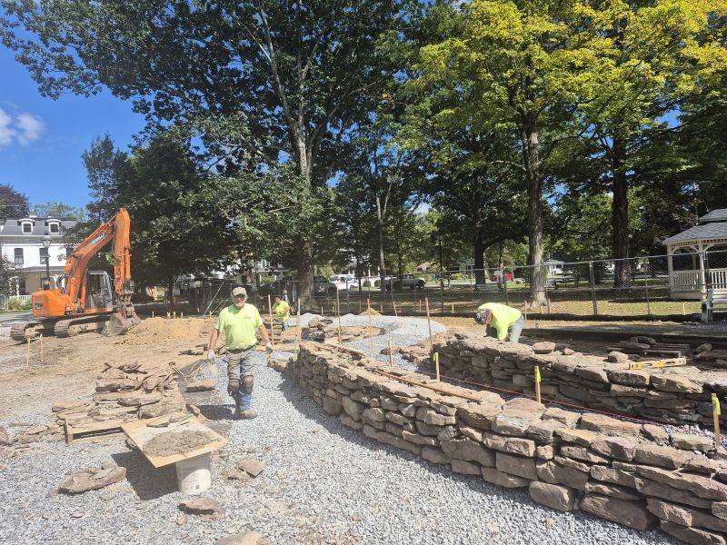 Crew building stone retaining wall at Ann Street Park